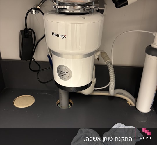 מתקן טוחן אשפה מתחת לכיור במטבח